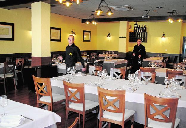 Dos camareros preparan el comedor de El Casón de los Reyes, en Caravaca de la Cruz. / j. f. robles