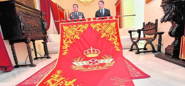 Miguel Ivorra Ruiz y Fulgencio Gil Jódar, ayer, con el repostero que la ciudad le ha regalado a la Academia General del Aire. / paco alonso / agm