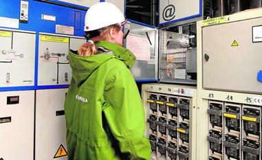 Una empleada de Iberdrola examina el cuadro de contadores de un bloque de pisos./AVELINO GÓMEZ