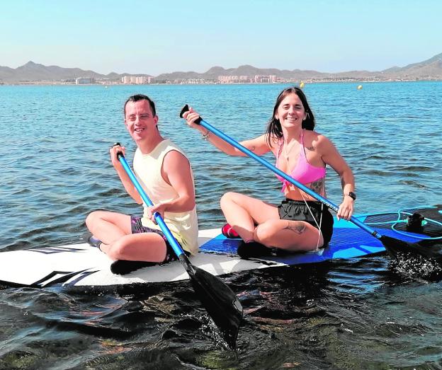 A SOI Cartagena user performs paddle surfing with his support professional.