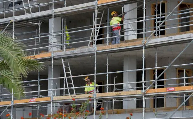Workers in a building under construction in Murcia, in a file photo.