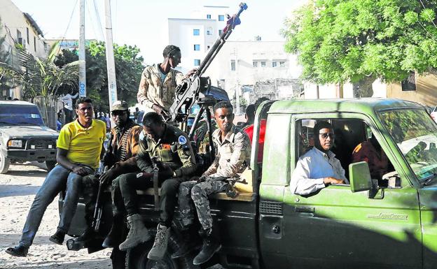 Military sympathizers to Prime Minister Hussein Roble travel in their vans through the Hodan district in the capital, Mogadishu.