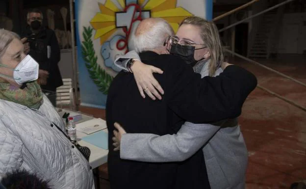 The new older sister receives the effusive hug of a brother after her election