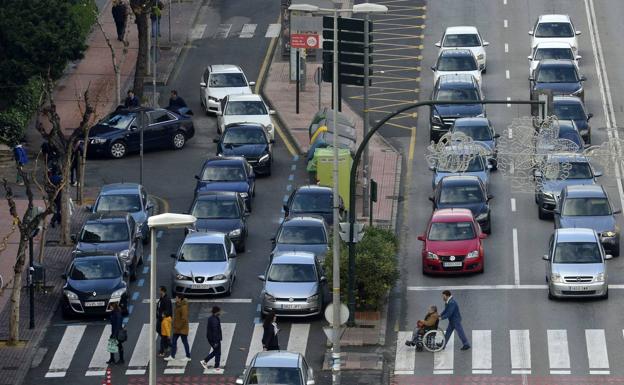 Cars drive down a street in Murcia. 