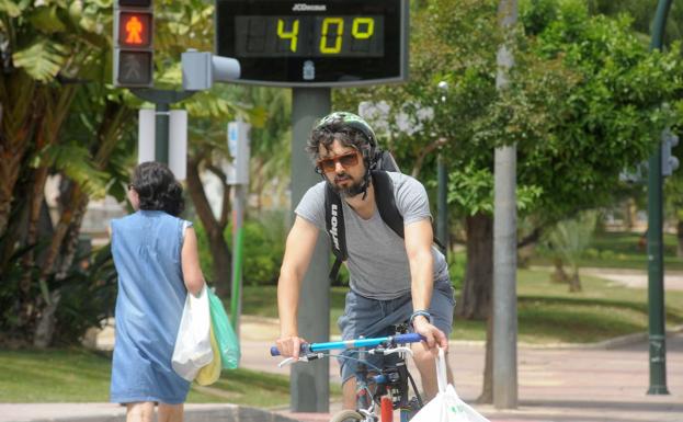 A man rides a bicycle through Murcia on a day of extreme heat, in a file photograph.