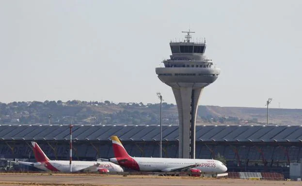 Two planes of the Iberia company stations at the Adolfo Suárez Madrid-Barajas Airport.