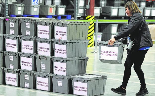 An election official stacks ballot boxes in Las Vegas. 