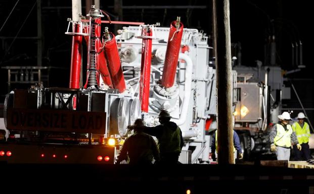 Workers for the state power company, Duke Energy, try to restore power to an electrical substation damaged after the attack that caused a massive power outage in North Carolina. 