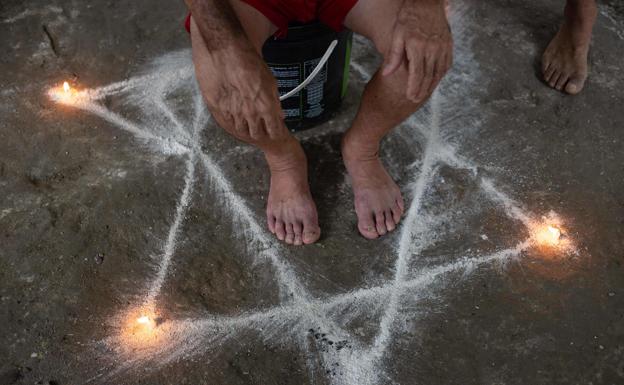 A Santeria devotee performs a ritual in Venezuela.
