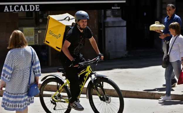 A Glovo worker circulates down a street in a file photograph. 