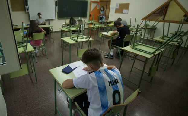 Several students take an exam in a secondary school classroom, in a file image. 