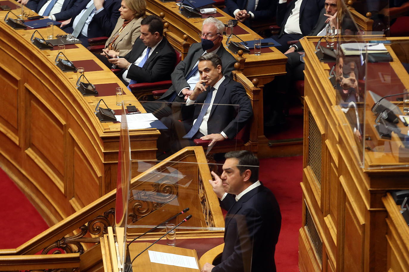 Greek Prime Minister Mitsotakis listens to opposition leader Alexis Tsipras's speech in Parliament